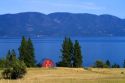 Red barn and farmland along Flathead Lake, Montana, USA.