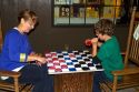 Grandmother and grandson play a game of checkers at a Cracker Barrel in Brandon, Florida, USA.
