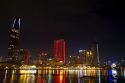 Night view of city lights reflected on the Saigon River in Ho Chi Minh City, Vietnam.