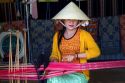 Vietnamese woman weaving silk into cloth near Da Lat, Vietnam.