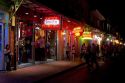 Business on Bourbon Street at night in the French Quarter, New Orleans, Louisiana, USA.